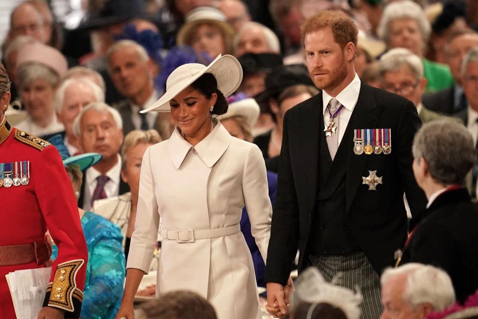 Britain's Prince Harry, Duke of Sussex (R) and Britain's Meghan, Duchess of Sussex attend the National Service of Thanksgiving for The Queen's reign at Saint Paul's Cathedral in London on June 3, 2022 as part of Queen Elizabeth II's platinum jubilee celebrations. - Queen Elizabeth II kicked off the first of four days of celebrations marking her record-breaking 70 years on the throne, to cheering crowds of tens of thousands of people. But the 96-year-old sovereign's appearance at the Platinum Jubilee -- a milestone never previously reached by a British monarch -- took its toll, forcing her to pull out of a planned church service. (Photo by Aaron Chown / POOL / AFP) (Photo by AARON CHOWN/POOL/AFP via Getty Images)