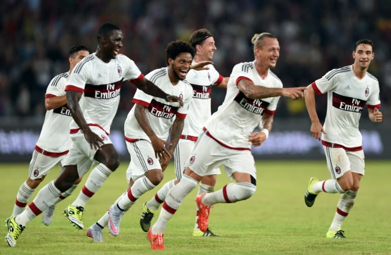 AC Milan players celebrate with defender Philippe Mexes (2nd R) after he scores during the International Champions Cup match against Inter Milan in Shenzhen on July 25, 2015