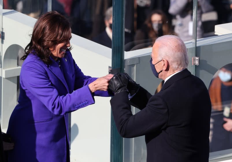 WASHINGTON, DC - JANUARY 20: Vice President Kamala Harris celebrates with President-elect Joe Biden after being sworn in during the inauguration on the West Front of the U.S. Capitol on January 20, 2021 in Washington, DC. During today's inauguration ceremony Joe Biden becomes the 46th president of the United States. (Photo by Tasos Katopodis/Getty Images)