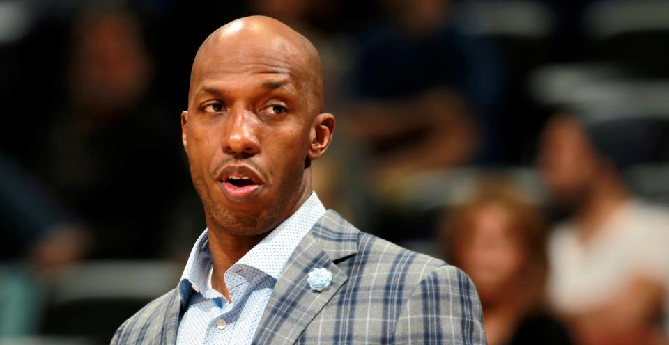Chauncey Billups watches from the sideline during an NBA basketball game against the Denver Nuggets in Denver.