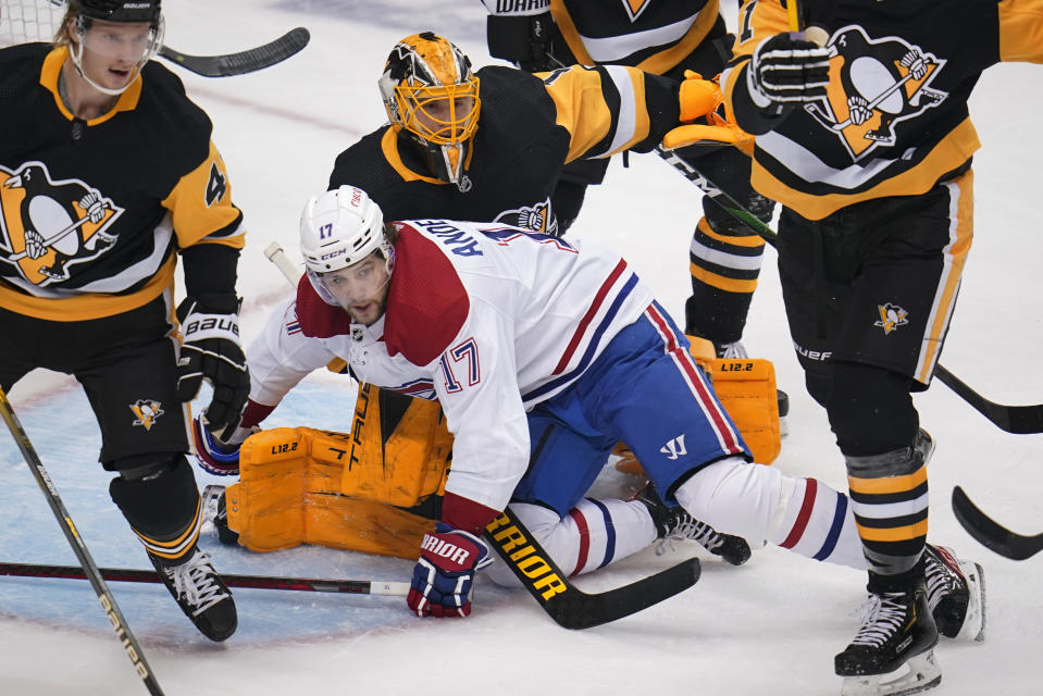 Montreal Canadiens' Josh Anderson (17) collides with Pittsburgh Penguins goaltender Casey DeSmith (1) during the first period of an NHL hockey game in Pittsburgh, Saturday, Nov. 27, 2021. (AP Photo/Gene J. Puskar)