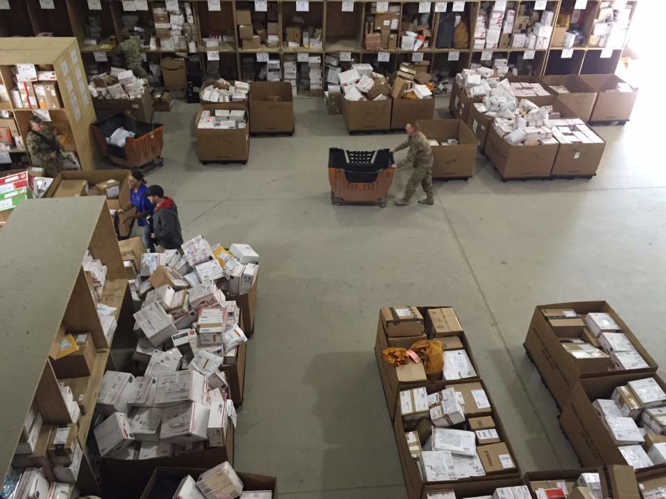 Holiday packages make their way through the Bagram Air Base postal facility in Afghanistan. A military contractor was convicted of shipping home to Texas laptops and hard drives full of classified records before his arrest in 2017.