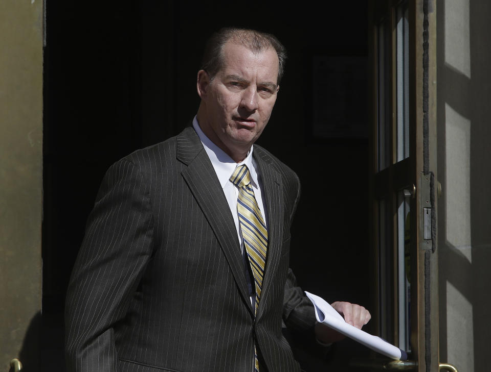 Former Central Falls, RI., mayor Charles Moreau walks out the front door of the Federal Courthouse in Providence, RI., as a free man Friday, Feb. 28, 2014. Moreau was released from federal prison Friday after serving just under one year of a two-year sentence. Moreau was released after first pleading guilty to a new charge of accepting a bribe and being sentenced on that charge to time served. As part of the deal, U.S. District Court Judge John McConnell then vacated Moreau's 2012 conviction, allowing him to walk free. (AP Photo/Stephan Savoia)