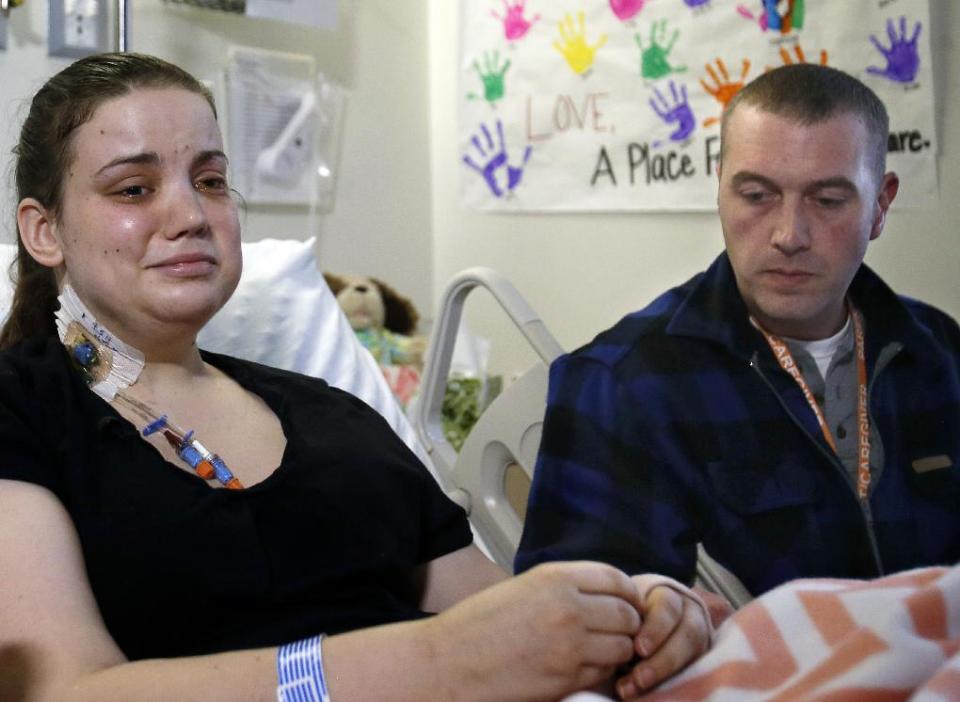 Washington mudslide survivor Amanda Skorjanc, left, talks to the media with her partner Ty Suddarth at Harborview Medical Center, Wednesday, April 9, 2014, in Seattle. On March 22, Skorjanic said she was trapped in a pocket formed by her broken couch and pieces of her roof with her infant son. Skorjanic had two broken legs and a broken arm. (AP Photo/The Herald, Dan Bates, Pool)