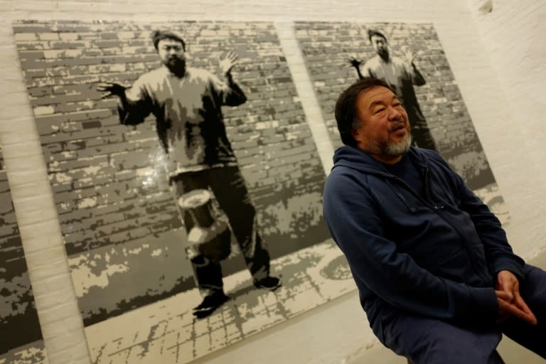 Chinese artist Ai Weiwei speaks to AFP in front of his work "Dropping a Han Dynasty Urn, 2016" in his studio in Berlin