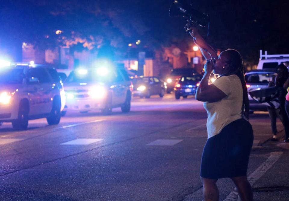 Danasha Cloud of Rock Hill speaks to a crowd from a loud speaker Thursday in downtown Rock Hill.