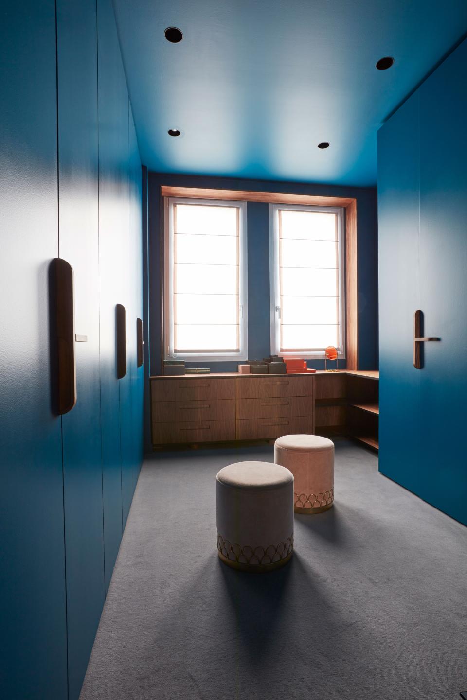 In the wardrobe, the rich blue color covers the doors, ceilings, and walls.