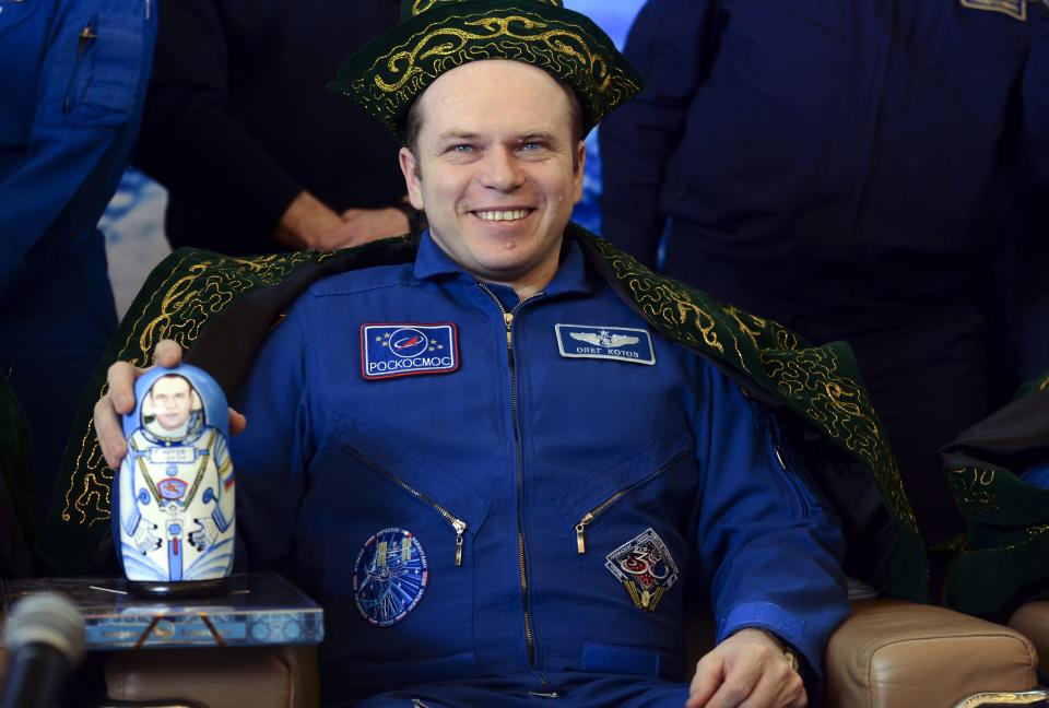 Former ISS commander Oleg Kotov of Russia attends a news conference, wearing a traditional Kazakh hat and costume, in Karaganda, March 11, 2014. An American astronaut and two Russians who carried a Sochi Olympic torch into open space landed safely and on time on Tuesday in Kazakhstan, defying bad weather and ending their 166-day mission aboard the International Space Station (ISS). Inside the capsule were Kotov and flight engineers Sergei Ryazansky and Michael Hopkins from NASA. The trio launched together into space on September 25. REUTERS/Vasily Maximov/Pool (KAZAKHSTAN - Tags: TRANSPORT SCIENCE TECHNOLOGY)