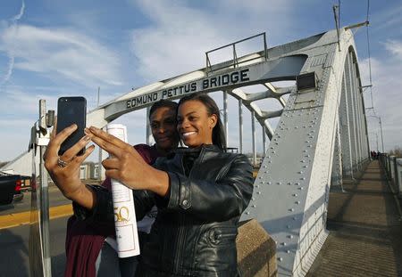 Lazette Bowens (L) and her daughter Zoe take a selfie at the Edmund Pettus Bridge in Selma, Alabama March 6, 2015. REUTERS/Tami Chappell