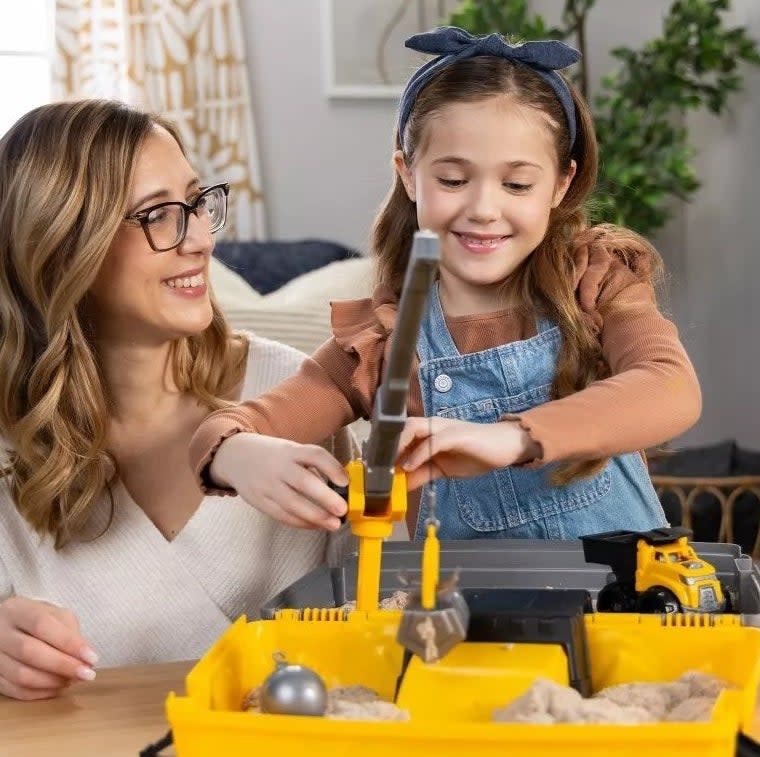 Adult and child engaging with a toy construction set