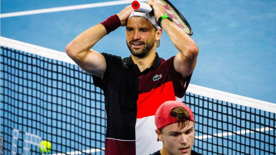 Grigor Dimitrov places his hands on his head after winning the Brisbane International