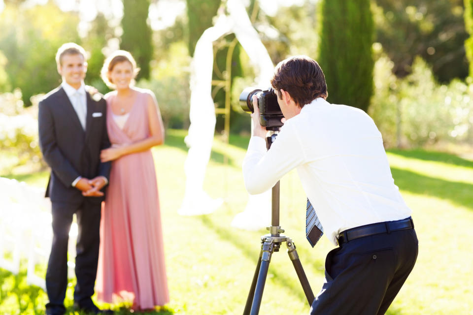 photographer taking pictures of a couple outside