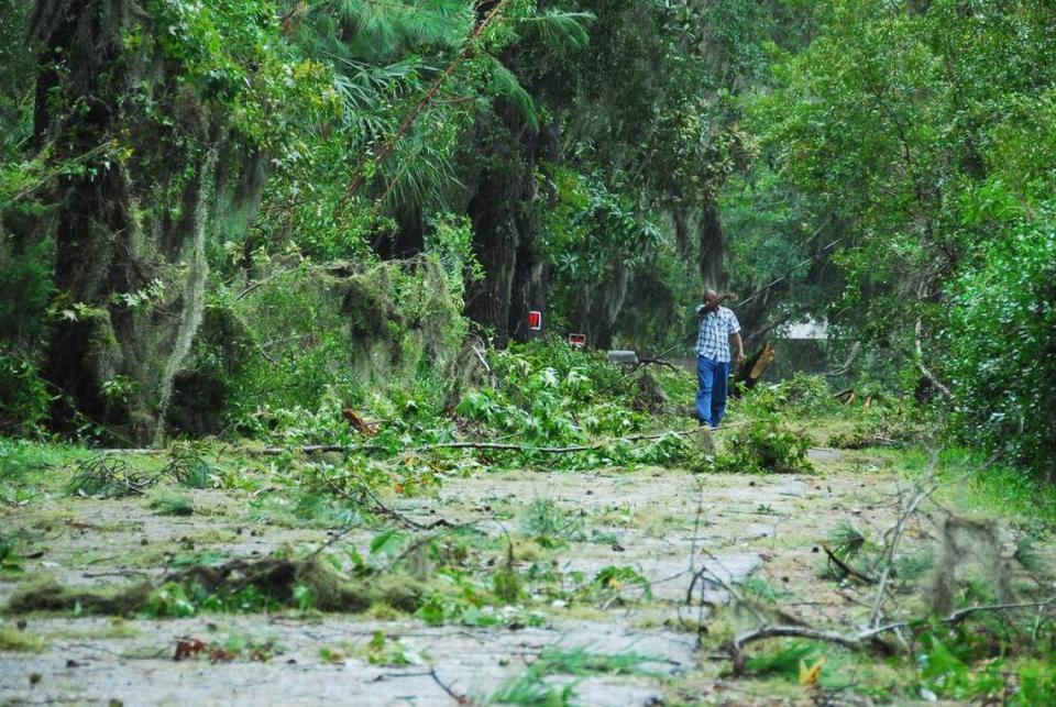 A man walks among the debris on a street in Bluffton after Hurricane Matthew hit.