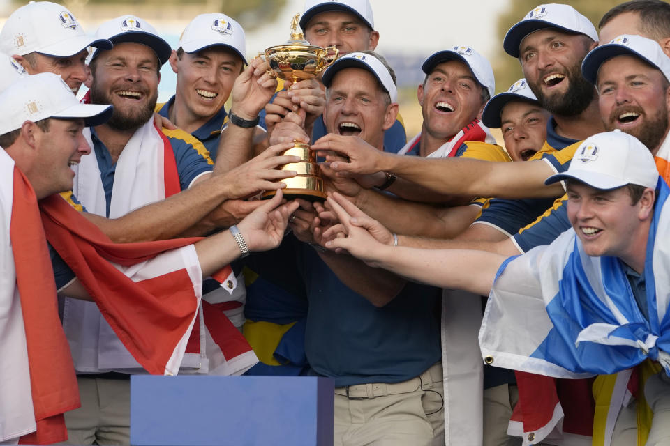 The Europe team led by Europe's Team Captain Luke Donald, at center, lift the Ryder Cup after winning it at the Marco Simone Golf Club in Guidonia Montecelio, Italy, Sunday, Oct. 1, 2023. (AP Photo/Alessandra Tarantino)