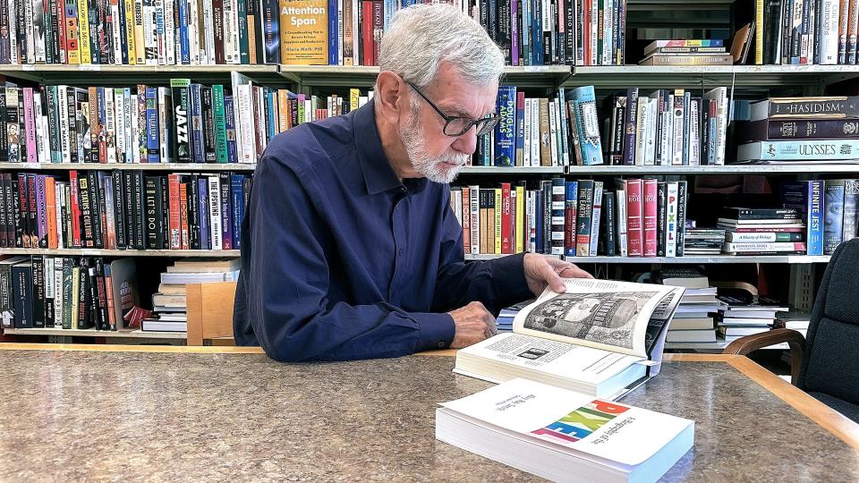 Richard Connolly, Rockland Community College's longest serving tenured professor, reads books in preparation for work with students.