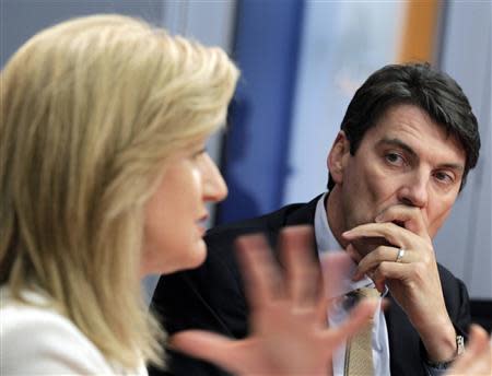 Tim Armstrong (R), AOL Chairman and Chief Executive Officer, listens to Arianna Huffington, president and Editor-in-Chief of The Huffington Post Media Group, speak during the Reuters Global Technology Summit in New York in this May 16, 2011, file photo. REUTERS/Brendan McDermid/Files