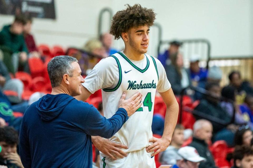 Great Crossing High School boys basketball head coach Steve Page (left) and center Malachi Moreno talk at the end of a win over Male in the Dan Cummins Classic on Saturday Jan. 20, 2024 at Scott County High School in Georgetown, Ky.