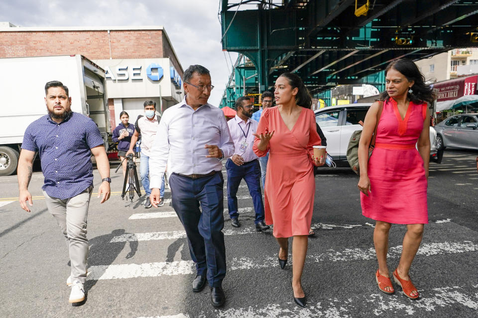 Rep. Alexandria Ocasio-Cortez, D-N.Y., second rom right, talks to Chhaya Community Development Corporation Executive Director Annetta Seecharran right, and Urged Sherpa as they walk through the Jackson Heights neighborhood of the Queens borough of New York, Wednesday, July 6, 2022. As she seeks a third term this year and navigates the implications of being celebrity in her own right, she's determined to avoid any suggestion that she is losing touch with her constituents. (AP Photo/Mary Altaffer)