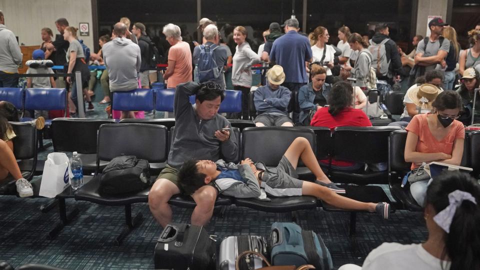 People gather at the Kahului Airport while waiting for flights.