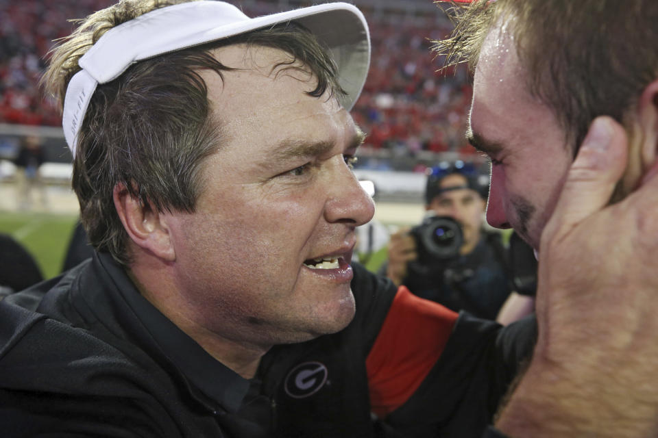Georgia coach Kirby Smart, left, congratulates quarterback Jake Fromm after the team's 24-17 win over Florida in an NCAA college football game Saturday, Nov. 2, 2019, in Jacksonville, Fla. (Bob Andres/Atlanta Journal Constitution via AP)