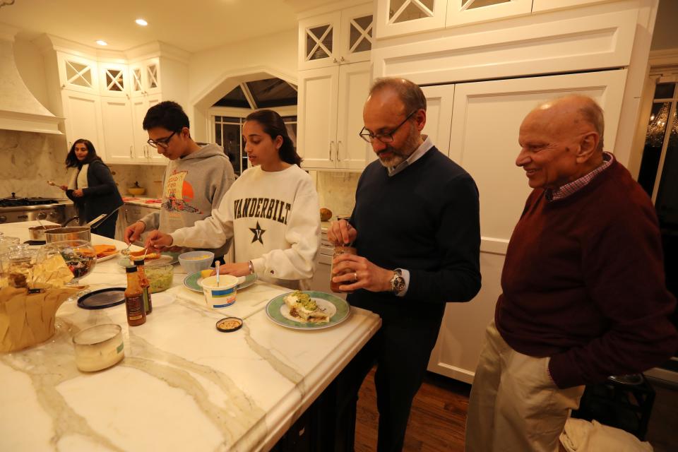 From left, Bella Sheth, her son Kiran, 16, daughter Serena, 18, her husband Haresh, and Rashmi Sheth, Hareth's father, put together a Mexican dinner at their home in Chappaqua April 1, 2019. 
The family spoke about the fact that that there are two Democratic candidates for President with Indian and Hindu connections.