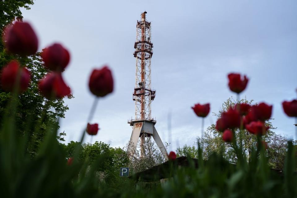 Russian forces struck a television broadcasting tower, causing the top half of the mast to collapse in Kharkiv, Ukraine, on April 22, 2024. (Serhii Korovayny/The Kyiv Independent)