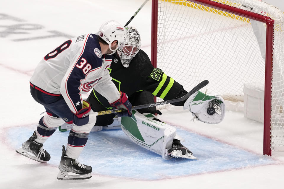 Dallas Stars goaltender Jake Oettinger (29) blocks a shot by Columbus Blue Jackets center Boone Jenner (38) in the third period of an NHL hockey game, Monday, Oct. 30, 2023, in Dallas. (AP Photo/Tony Gutierrez)