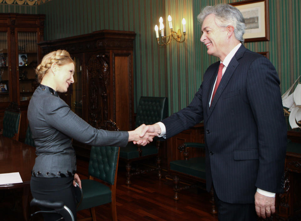 Former Ukrainian Prime Minister Yulia Tymoshenko shakes hands with US Deputy Secretary of State William Burns in Kiev, Ukraine, Wednesday Feb. 26, 2014. The campaign for Ukraine's early May 25 presidential election began Tuesday, with Yanukovych's archrival — former Prime Minister Yulia Tymoshenko — widely seen as a top contender for the post. (AP Photo/Pool)