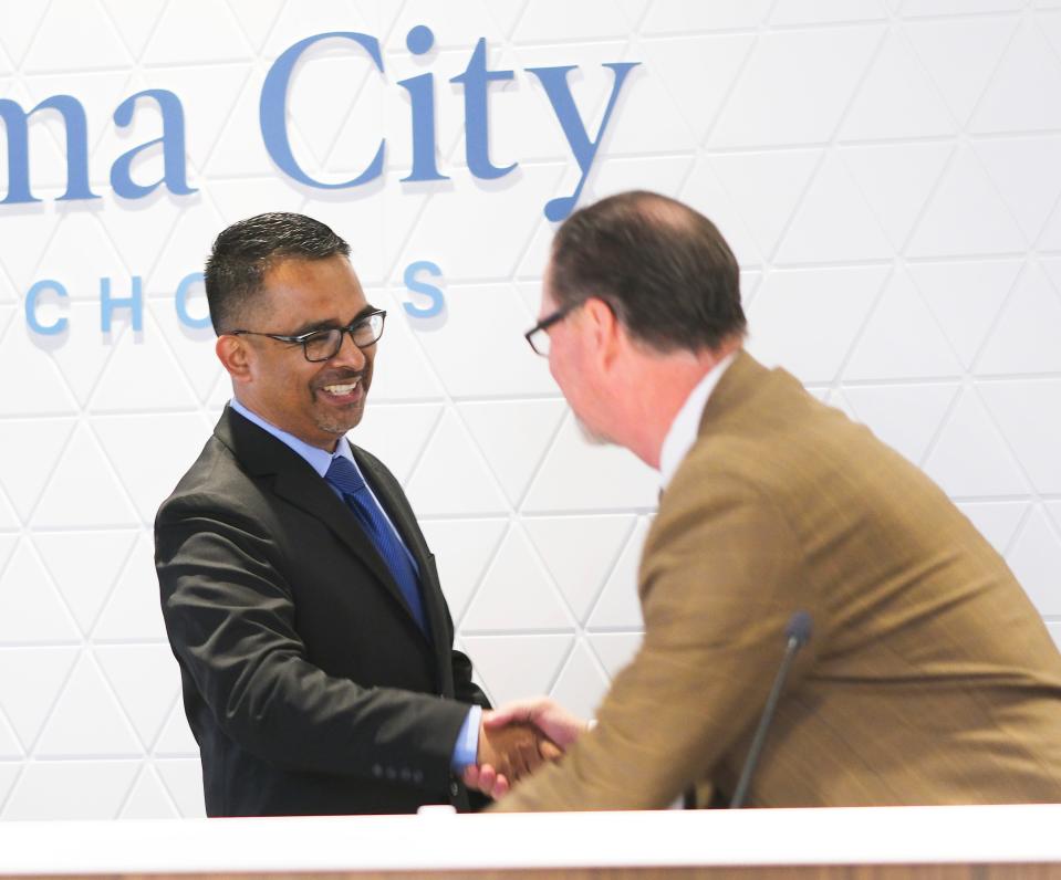 Oklahoma City Public Schools Superintendent Sean McDaniel welcomes new school board member Juan Lecona at a board meeting Monday at the Clara Luper Center for Educational Services.