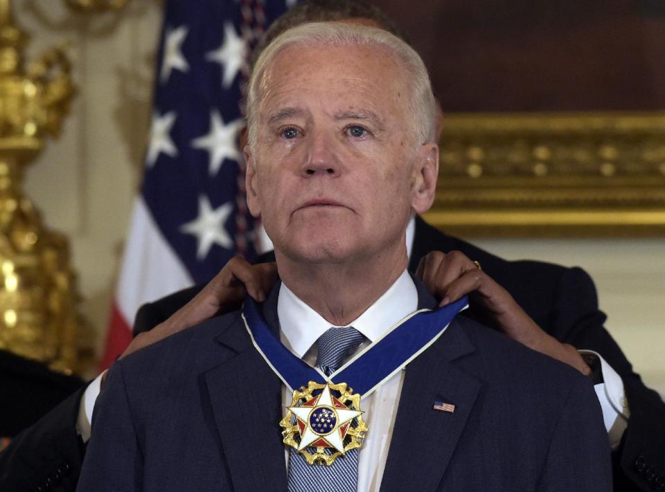 President Barack Obama honors Vice President Joe Biden during a ceremony in the State Dining Room of the White House in Washington, Thursday, Jan. 12, 2017, with the Presidential Medal of Freedom. (AP Photo/Susan Walsh)