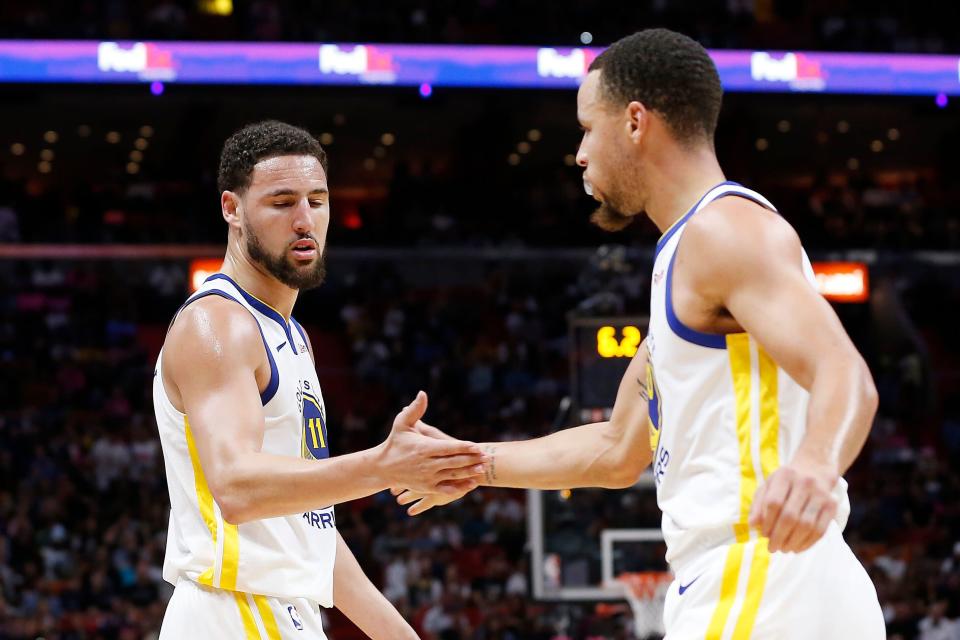 MIAMI, FLORIDA - FEBRUARY 27:  Klay Thompson #11 of the Golden State Warriors celebrates with Stephen Curry #30 against the Miami Heat at American Airlines Arena on February 27, 2019 in Miami, Florida. NOTE TO USER: User expressly acknowledges and agrees that, by downloading and or using this photograph, User is consenting to the terms and conditions of the Getty Images License Agreement. (Photo by Michael Reaves/Getty Images)