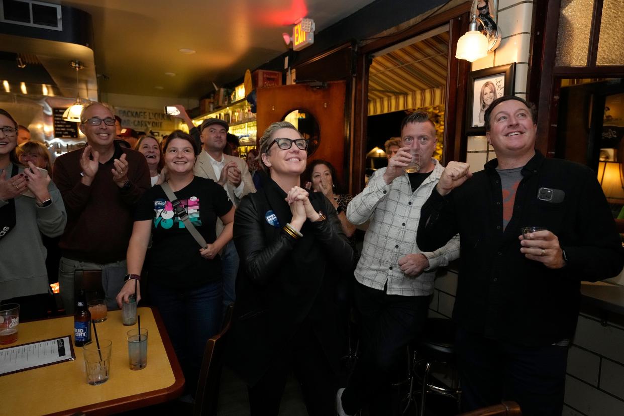 Kentucky state Rep. Rachel Roberts, center, and Newport Mayor Tom Guidugli, far right, cheer while watching election results at Jerry's Jug House in Newport as Andy Beshear takes the lead over Daniel Cameron in the Kentucky gubernatorial race.