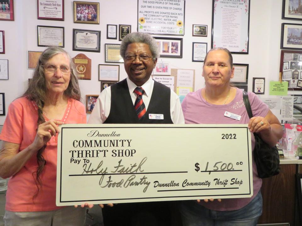 Dunnellon Community Thrift Shop's Janis Edwards (left) presents a $1,500 check to Odum Smith and Connie Stevens, directors of the Holy Faith Episcopal Church Food Pantry.