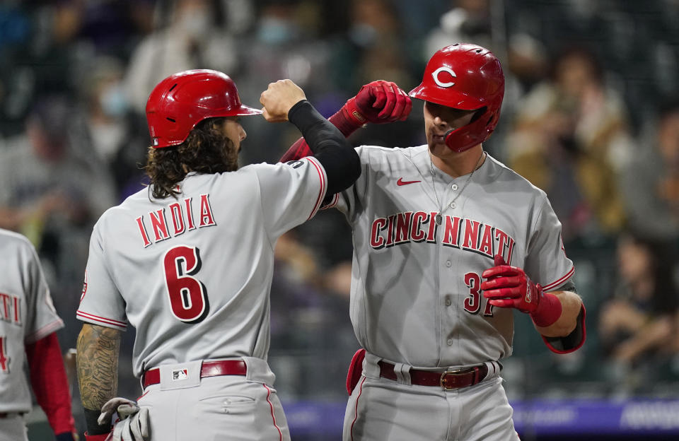 Cincinnati Reds' Jonathan India, left, congratulates Tyler Stephenson as he crosses home plate after hitting a two-run home run off Colorado Rockies relief pitcher Lucas Gilbreath during the eighth inning of a baseball game Thursday, May 13, 2021, in Denver. (AP Photo/David Zalubowski)