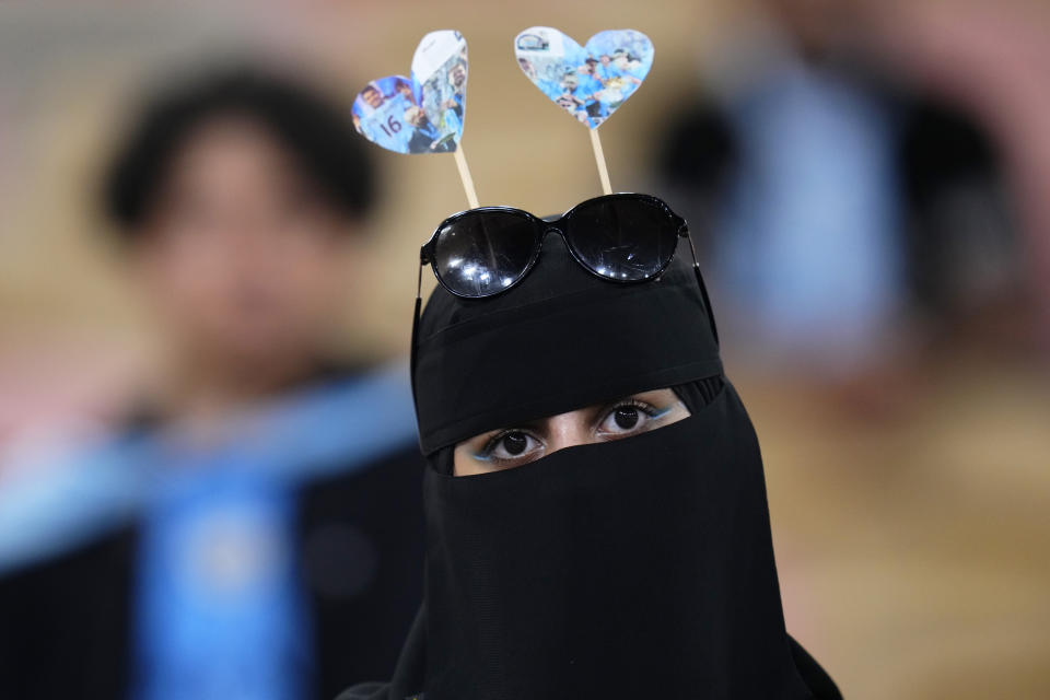 A Manchester City fan attends the trophy ceremony after the end of the Soccer Club World Cup final match between Manchester City FC and Fluminense FC at King Abdullah Sports City Stadium in Jeddah, Saudi Arabia, Friday, Dec. 22, 2023. Manchester City won 4-0. (AP Photo/Manu Fernandez)