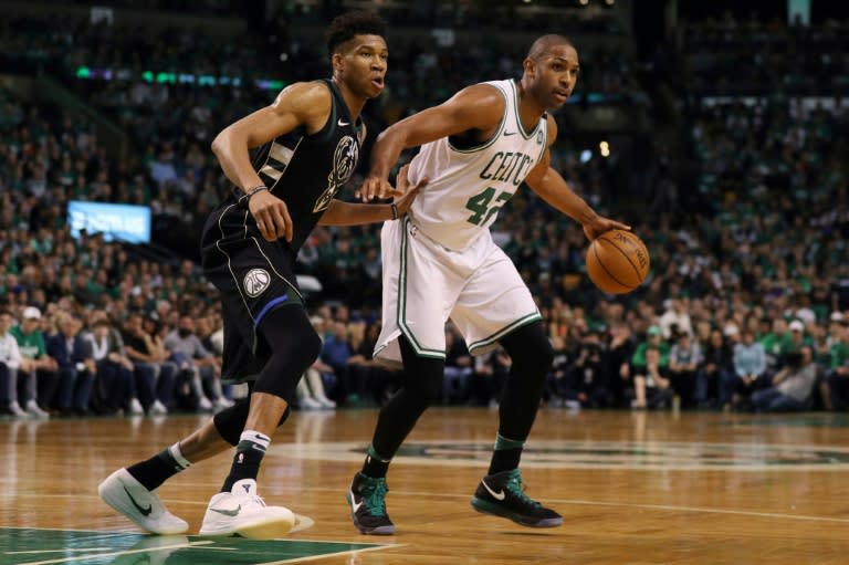 Giannis Antetokounmpo (L) of the Milwaukee Bucks defends Al Horford of the Boston Celtics on April 15, 2018 in Boston, Massachusetts