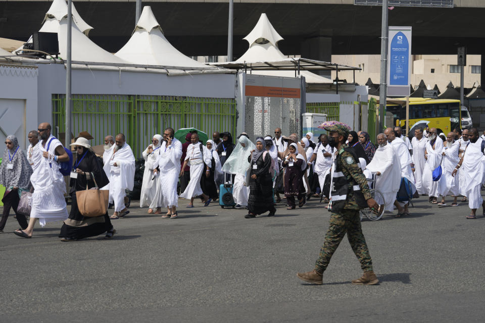 Muslim pilgrims arrive at the Mina tent camp during the annual Hajj pilgrimage, near the holy city of Mecca, Saudi Arabia, Friday, June 14, 2024. Hajj is the annual Islamic pilgrimage to Mecca in Saudi Arabia that is required once in a lifetime of every Muslim who can afford it and is physically able to make it. Some Muslims make the journey more than once. (AP Photo/Rafiq Maqbool)