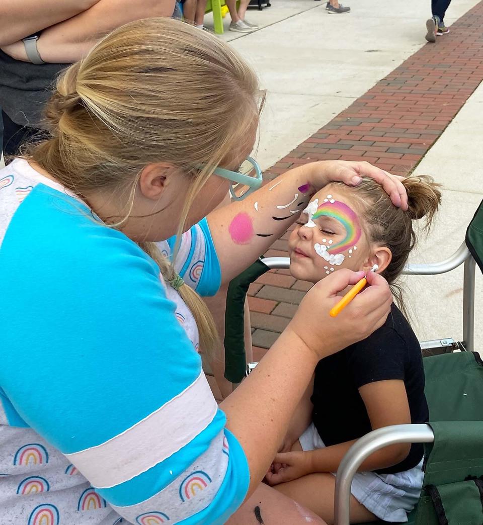 Amelia Jordan gets a face-painting by Jessica Higginbotham at “Summer Car Cruise-in & Eats.”