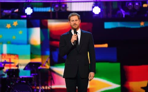 Prince Harry speaking on stage at the birthday concert - Credit: Andrew Parsons