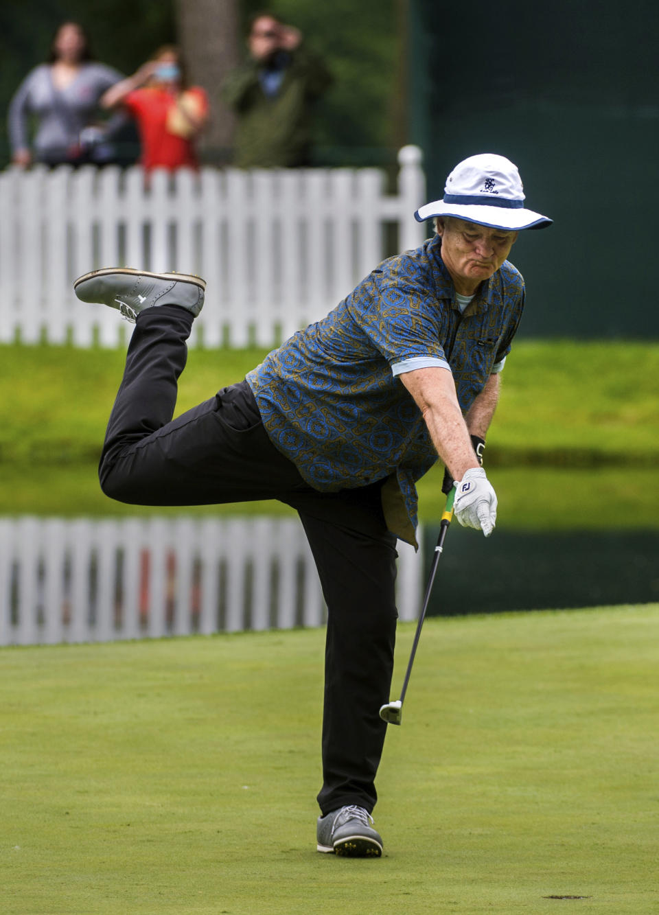 FILE - In this July 8, 2015, file photo, actor Bill Murray celebrates as he drops his final putt drops in on the 18th during the John Deere Classic Pro-Am, in Silvis, Ill. "Caddyshack" starring Murray was No. 4 in The Associated Press’ Top 25 favorite sports movies poll. (Fred Zwicky/Journal Star via AP)