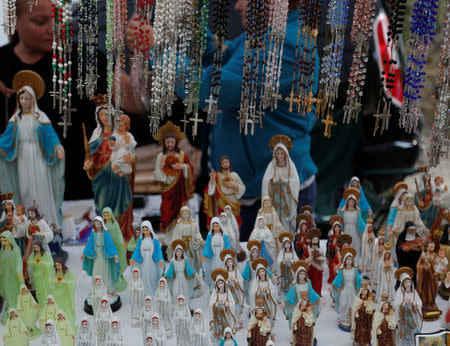 Statues of the Virgin Mary and rosaries on sale at a stand near the chapel in Csatka, Hungary on September 9, 2017. REUTERS/Laszlo Balogh