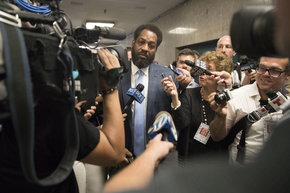 Attorney Norman Williams is surrounded by reporters after the arraignment of his client, James Currie, in Manhattan criminal court, Friday, Aug. 10, 2018, in New York. Currie is accused of throwing the lifeless body of his son, Mason Saldana, into the East River near the Brooklyn Bridge last Sunday. A tourist spotted the child's diaper-clad body and waded into the water to retrieve it. (AP Photo/Mary Altaffer)