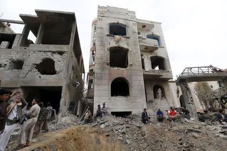 People gather at the site of a Saudi-led air strike in Yemen's capital Sanaa August 30, 2015. REUTERS/Khaled Abdullah