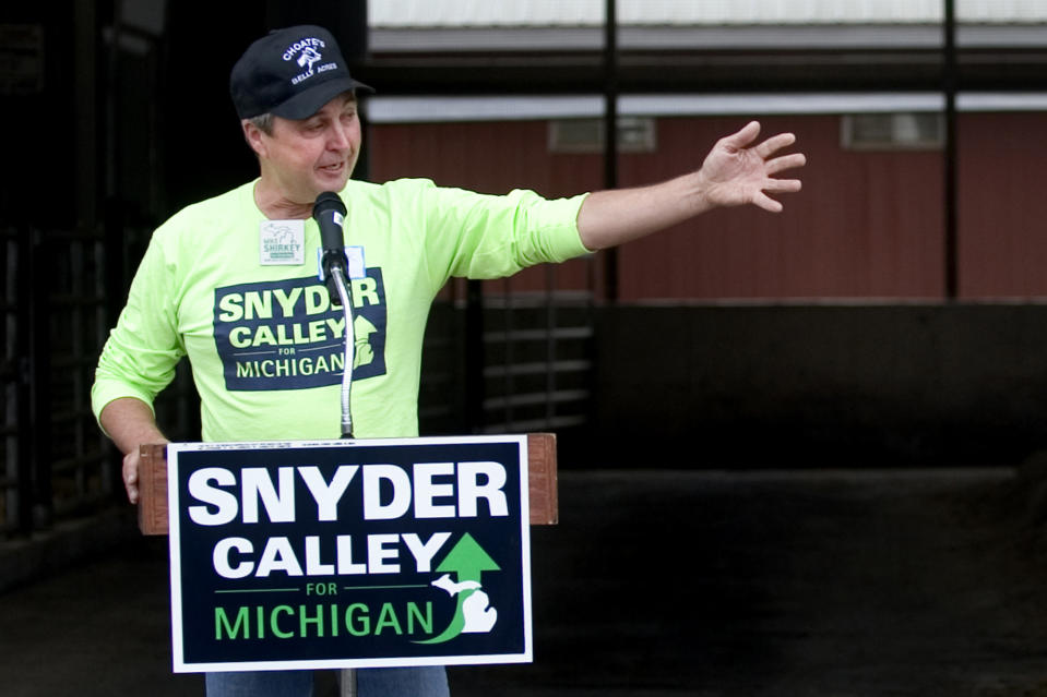 FILE - Hank Choate, co-owner of Choate's Belly Acres farm, introduces republican candidate for governor Rick Snyder after the pair toured the farm in Liberty Township near Cement City, Mich., Monday, Oct. 25, 2010. Michigan Attorney General Dana Nessel has charged 16 Republicans Tuesday, July 18, 2023, with multiple felonies after they are alleged to have submitted false certificates stating they were the state’s presidential electors despite Joe Biden’s 154,000-vote victory in 2020. The group includes Republican National Committeewoman Kathy Berden, Meshawn Maddock, former co-chair of the Michigan Republican Party, and Choate. (Katie Rausch/Jackson Citizen Patriot via AP, File)