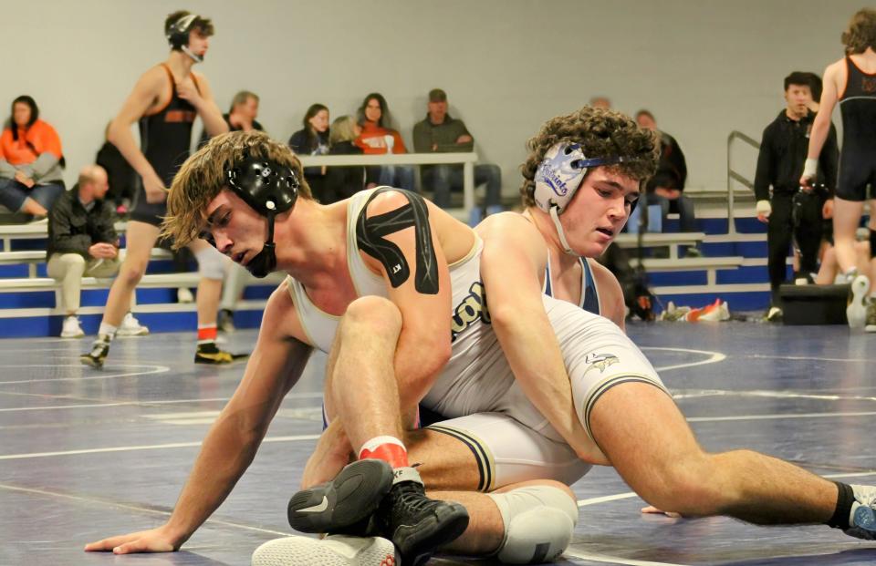 Olentangy Liberty’s Broc Fitzpatrick, back, competes against Teays Valley’s Ethan Schwalbauch during their match at 175 pounds in a Division I district dual tournament Saturday. Fitzpatrick won two matches by pin, helping the Patriots advance to the state.
