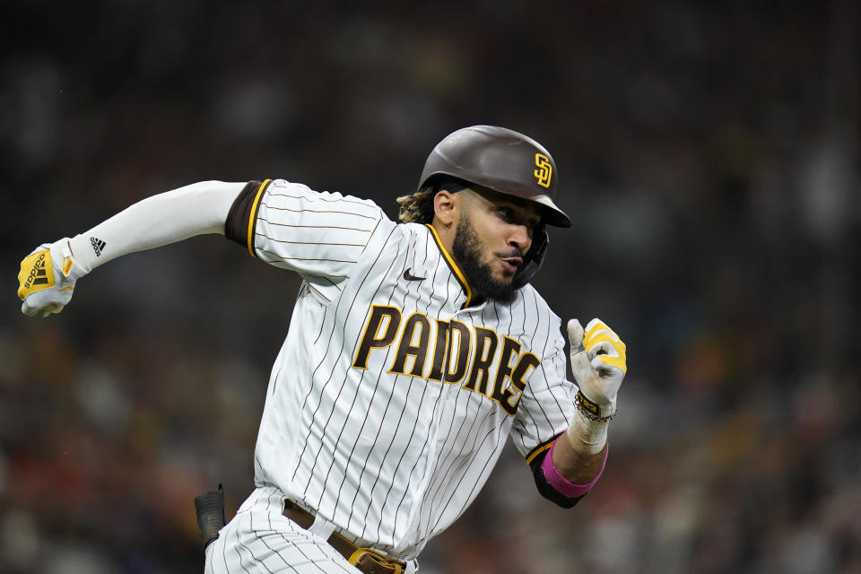 FILE - San Diego Padres' Fernando Tatis Jr. runs to first after hitting a single during the sixth inning of a baseball game against the San Francisco Giants, on Sept. 21, 2021, in San Diego. All-Star shortstop Fernando Tatis Jr. likely will need surgery for a broken left wrist and could miss up to three months, general manager A.J. Preller said on Monday, March 14, 2022. Tatis suffered the injury in the offseason, Preller said. (AP Photo/Gregory Bull, File)