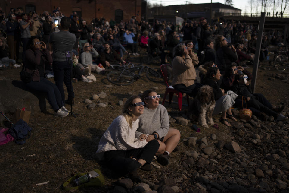 Skywatchers react to viewing the totality phase of a total solar eclipse in Fredericton, Monday, April 8, 2024. THE CANADIAN PRESS/Darren Calabrese