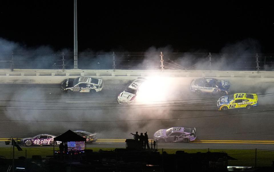 Kyle Larson (5) slammed the wall, setting off a massive crash in Turn 1 of the last lap of the Daytona 500. Ricky Stenhouse was ruled to be ahead of Joey Logano at the time of caution, giving him the win.