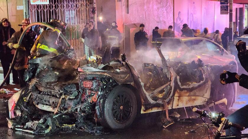 Waymo Vehicle surrounded and then graffiti'd, windows were broken, and firework lit on fire inside the vehicle which ultimately caught the entire vehicle on fire.