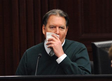 Defendant Michael Dunn, is shown in a television monitor as he reacts on the stand during testimony in his own defense during his murder trial in Duval County Courthouse in Jacksonville, Florida February 11, 2014. REUTERS/Bob Mack/Pool